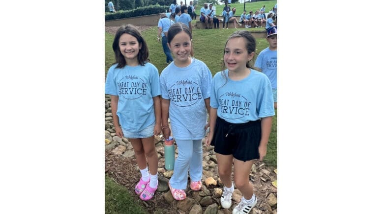 Three children wearing Whitefield Academy Great Day of Service t-shirts