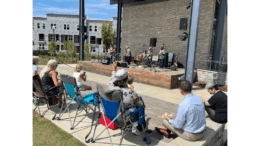 Several audience members at the City of Powder Springs' Sept. 21, 2023, Brown Bag Lunch Series Concert sit in the sunshine beaming into the Thurman Springs Park amphitheater seating as Incentive performed on stage a setlist of pop/rock songs spanning the modern decades.