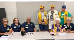 A group from area Lions Clubs at a vision screening table