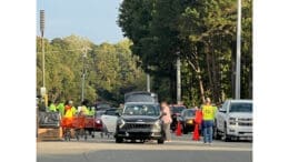 Volunteers collect hazardous waste from cars at Keep Cobb Beautiful's hazardous household waste event