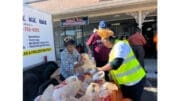 Volunteer distributing Thanksgiving food