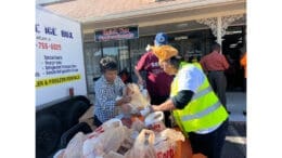 Volunteer distributing Thanksgiving food