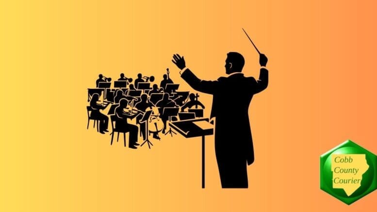 Silhouette of a conductor in front of a chamber orchestra