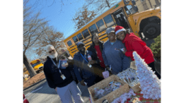 Group photo of community members with bus drivers