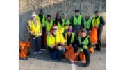 Group photo of volunteers at the latest Queen Mill Road litter cleanup hosted by Friends of Mableton and Keep Cobb Beautiful