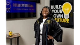 Toni-Ann McKenzie wearing graduation robe