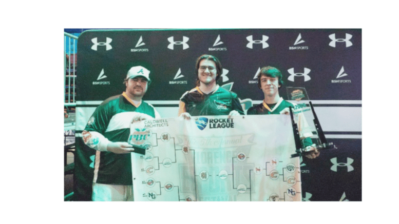Three members of KSU Esports team hold up awards