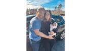 Photo of young couple holding newborn after a Cobb police officer saves the baby life