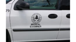 The logo on the side of the Cobb County Medical Examiner's vehicle