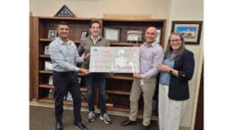 Unity North Atlanta Church and Habitat for Humanity NW Metro Atlanta officials pose for group shot with ceremonial check