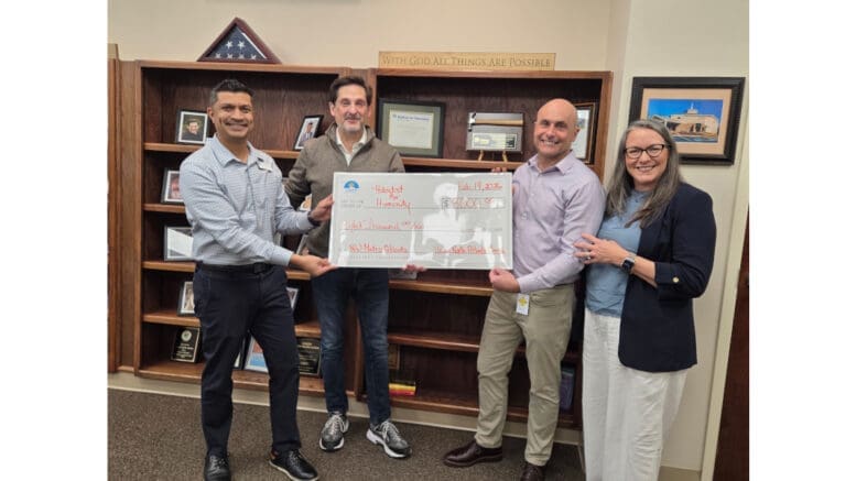 Unity North Atlanta Church and Habitat for Humanity NW Metro Atlanta officials pose for group shot with ceremonial check