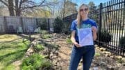 Woman holding up award received by Keep Smyrna Beautiful