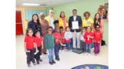Group photo of vision screening crew at Rising Star Learning Center, with children and Mableton Mayor Michael Owens