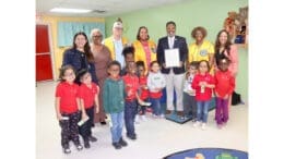 Group photo of vision screening crew at Rising Star Learning Center, with children and Mableton Mayor Michael Owens