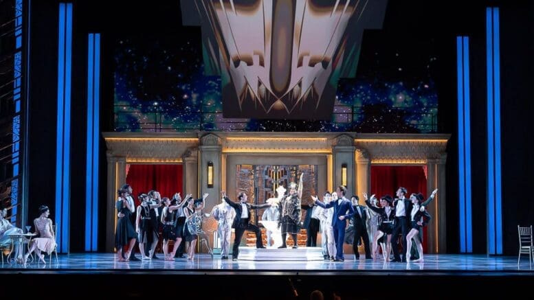 A stage scene from the Atlanta Ballet's Great Gatsby, with people in 1920s party dress lined up onstage