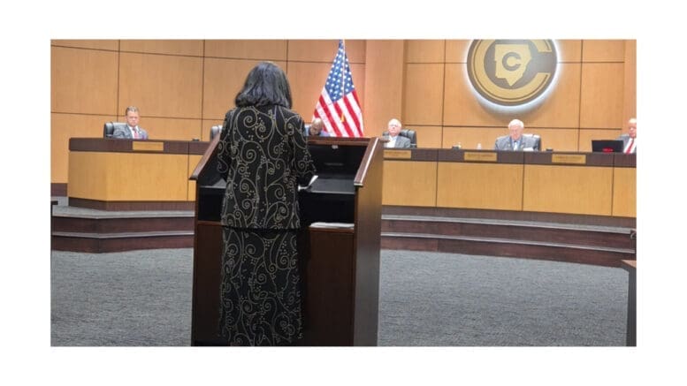 Public commenter at the microphone facing the Cobb County Board of Education