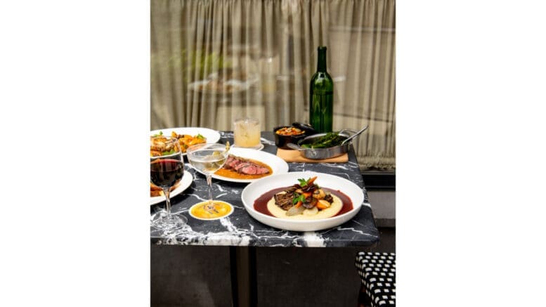 An elegant dinner spread with a bottle of wine