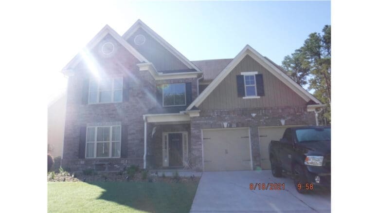 4099 Bunker Dr in South Cobb, highest-priced home sale of March 2026 at $550,000, two-story brick house with large driveway and front yard