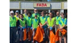 Boy Scout Troop 22 litter cleanup group photo with orange litter bags and yellow safety vests