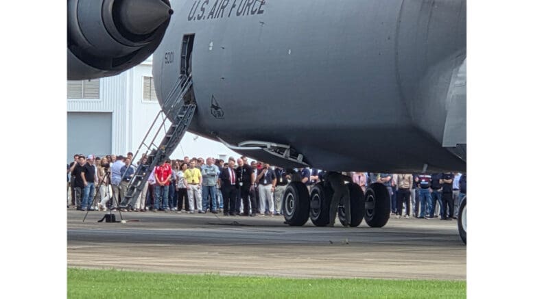 A crowd of people gather around a massive Lockheed Martin C-5