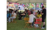 A crowd gathers under a big tent on Smyrna Village Green to watch Mexico's 2=0 victory over South Africa in the first World Cup game